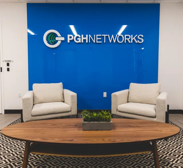The PGH Networks office lobby and branded logo wall
