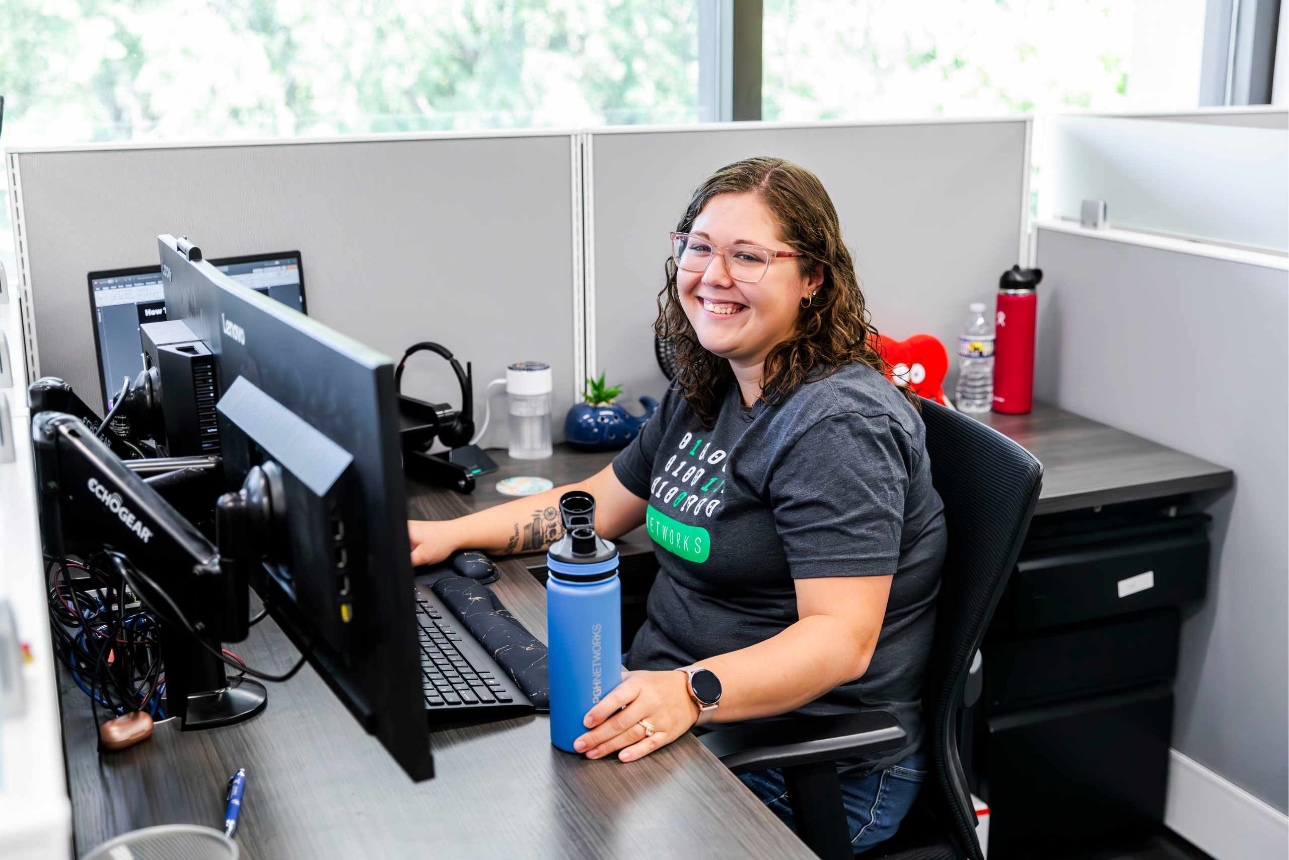 Woman Smiling at Computer